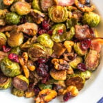 These roasted balsamic Brussels sprouts are absolutely delicious. Baked with dried cranberries, bacon and walnuts, they are a healthy, Whole30 side dish everyone will love. They're also paleo, gluten-free and low carb, and a really easy and tasty way to get vegetables on the table. With only 5 ingredients and 30 minutes, this is sure to be your go-to method for cooking brussels sprouts! #whole30vegetables #brusselssproutsrecipes #roastedbrusselssprouts #paleovegetables #baconrecipes #easyvegetablerecipes