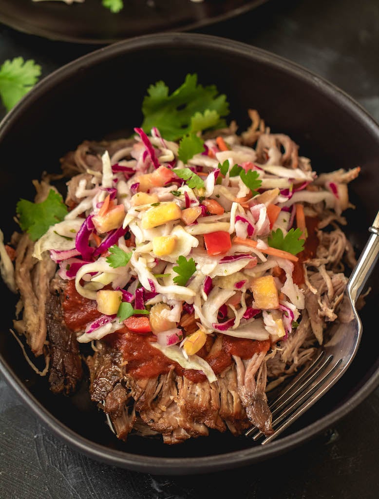 This Paleo and Whole30 slow cooker pulled pork with pineapple coleslaw is perfect for an easy weeknight dinner or meal prep. Made with BBQ sauce, delicious pineapple salsa and a creamy coleslaw, it's a combo you'll want to make again and again. It makes great leftovers, and it's hard to believe something so good is also so good for you! #whole30pulledpork #whole30slowcooker #paleopulledpork #paleoslowcooker