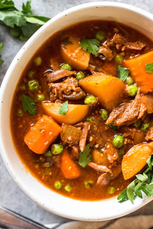 This easy slow cooker beef stew is hearty, healthy, and quick to prepare. Your crock pot will do all of the work, making this soup perfect for a weeknight dinner or meal prep recipe. It's paleo, Whole30, gluten-free, and super filling with the variety of vegetables and stew meat! #whole30beefstew #whole30slowcooker #slowcookerbeefstew #paleobeefstew #whole30beefrecipes #whole30souprecipes