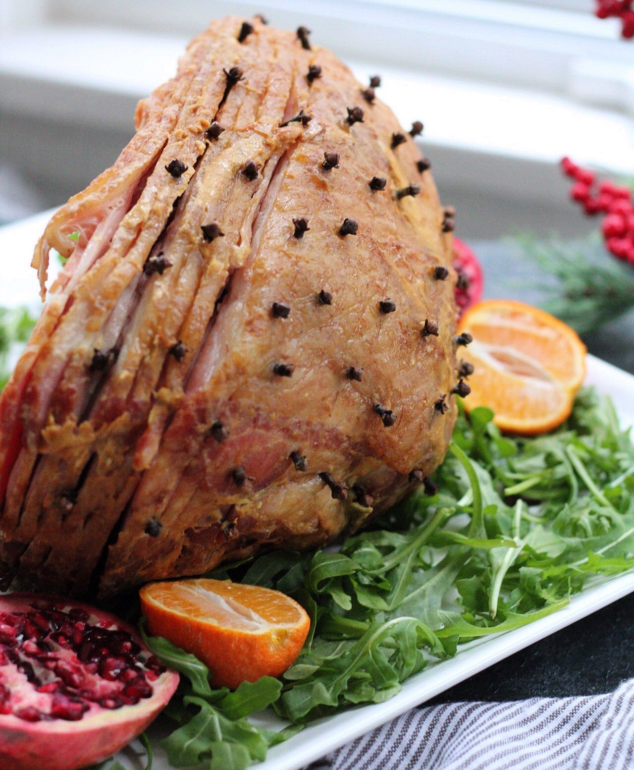 Three ingredient Whole30 holiday ham is a family friendly recipe everyone will enjoy. Made with a sugar free ham, this clean eating recipe will be a hit. With a simple recipe, it's quick and easy so you get in and out of the kitchen! #holidayham #paleoham #whole30ham #paleoholidayrecipes
