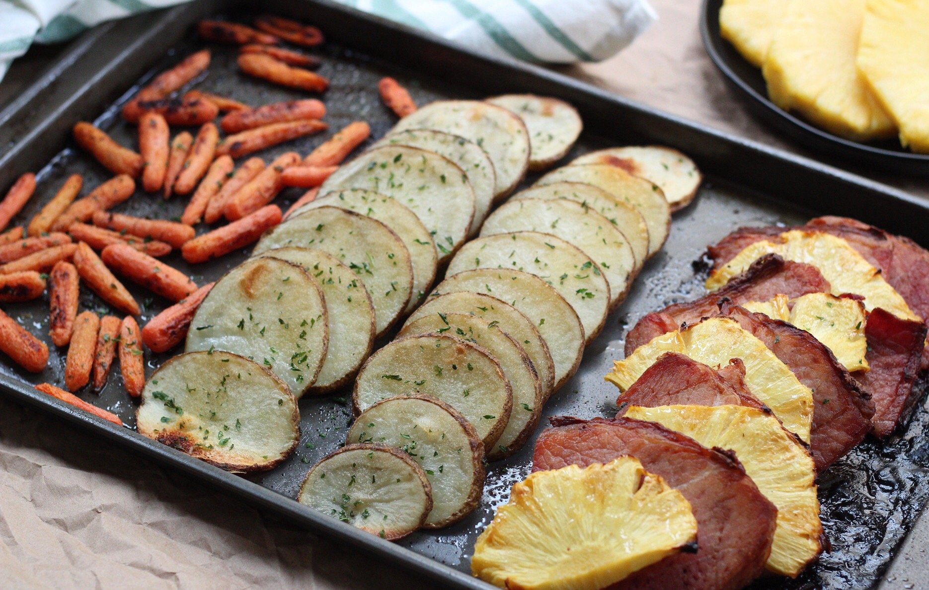 Simple and healthy pineapple ham Whole30 sheet pan dinner! This easy Paleo sheet pan meal is family friendly, and Whole30 when made sugar free ham. It's a great holiday leftover meal or an easy meal prep idea #sheetpan #hamrecipes #paleosheetpan #whole30sheetpan via @paleobailey