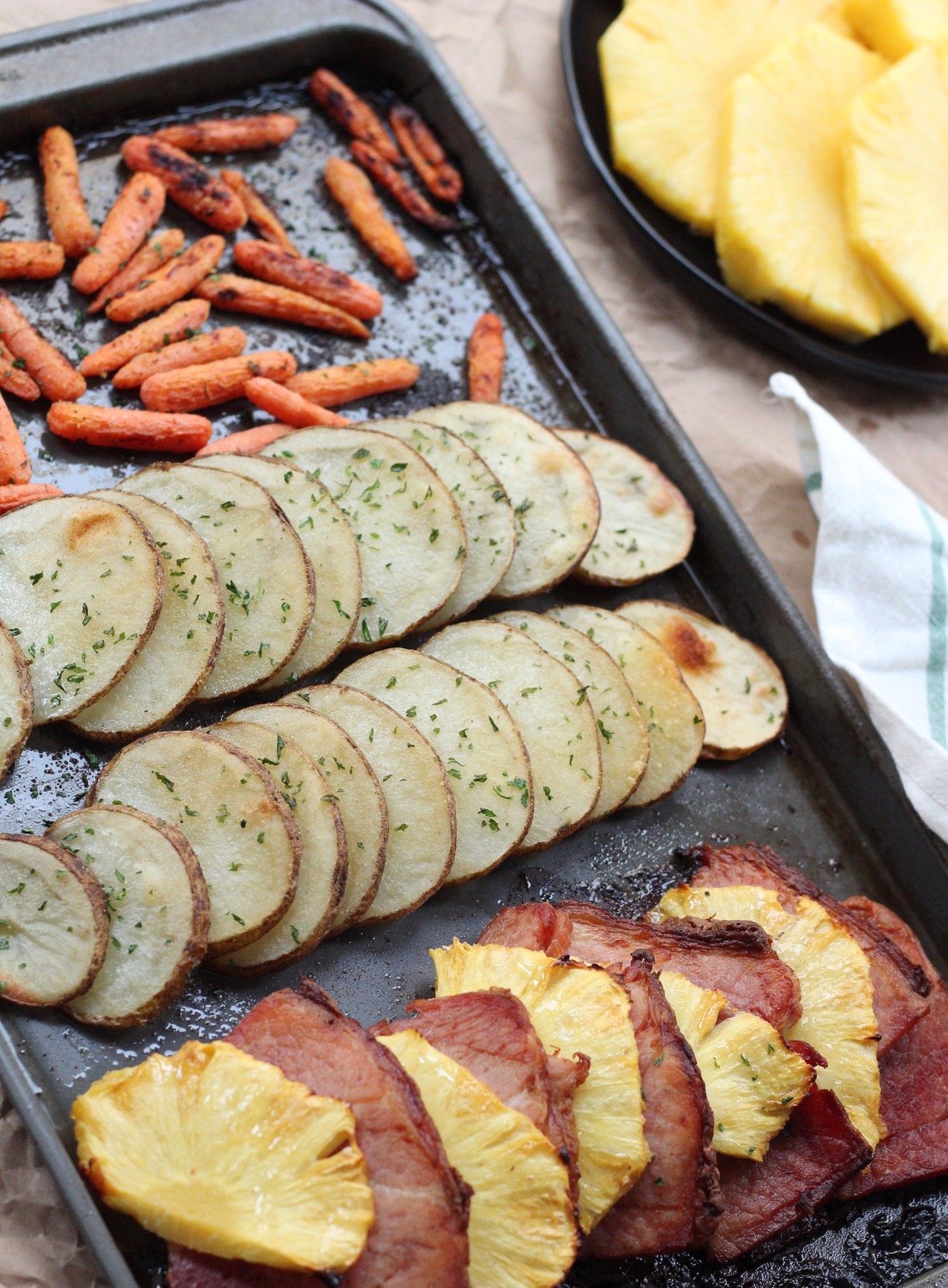 Simple and healthy pineapple ham Whole30 sheet pan dinner! This easy Paleo sheet pan meal is family friendly, and Whole30 when made sugar free ham. It's a great holiday leftover meal or an easy meal prep idea #sheetpan #hamrecipes #paleosheetpan #whole30sheetpan via @paleobailey