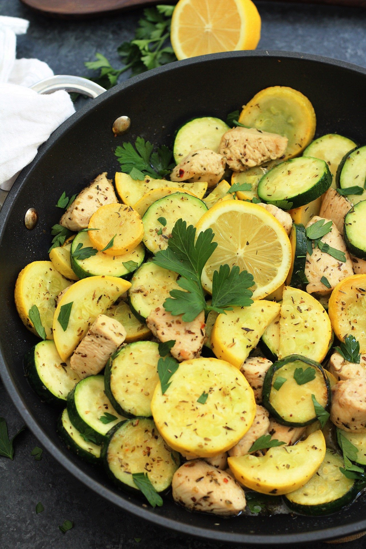 This Whole30 lemon chicken and squash skillet is Paleo, under 30 minutes, low carb and only made in one pot. This is a perfect summer dish for meal prep, or for a family friendly weeknight meal you won't have to heat up your kitchen for. #whole30lemonchicken #whole30onepot #paleochickenrecipes #whole30chickenrecipes