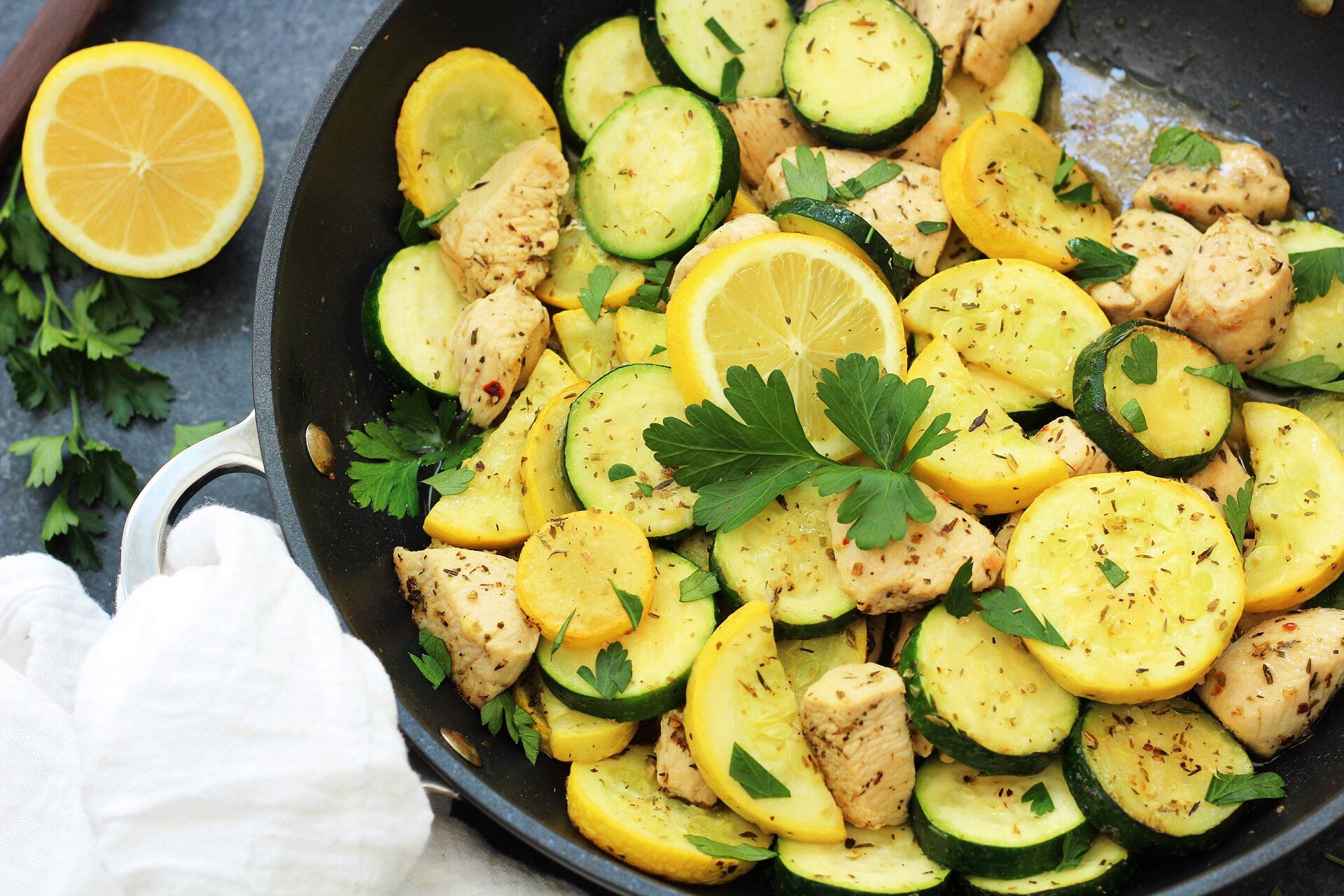 This Whole30 lemon chicken and squash skillet is Paleo, under 30 minutes, low carb and only made in one pot. This is a perfect summer dish for meal prep, or for a family friendly weeknight meal you won't have to heat up your kitchen for. #whole30lemonchicken #whole30onepot #paleochickenrecipes #whole30chickenrecipes
