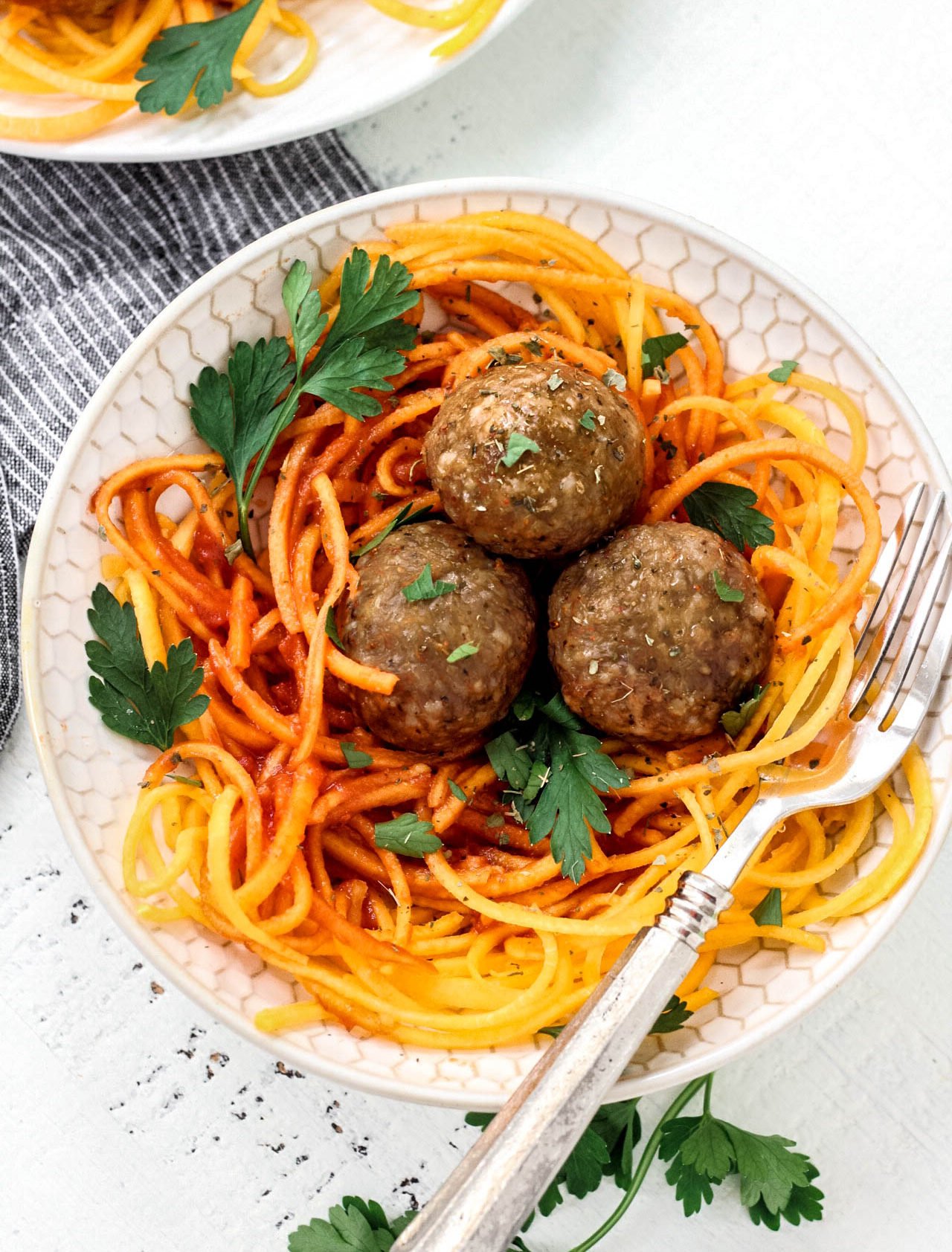 This easy meatball recipe is tried and true and the best way to make meatballs! Made paleo and Whole30 but still every bit as juicy and delicious. Served over butternut squash noodles and marinara here, the ways you can enjoy this low carb meatball recipe is endless!
