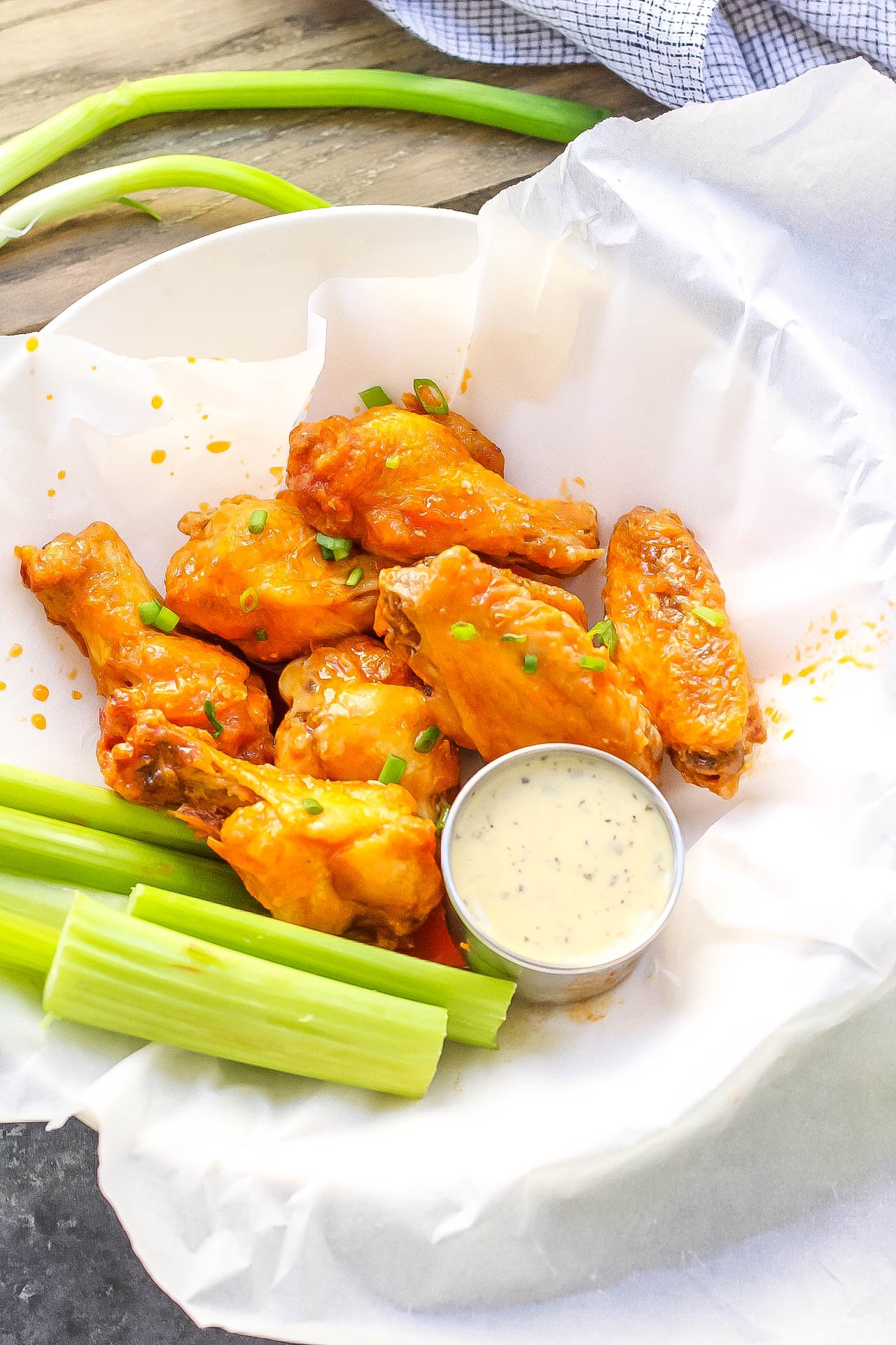 Healthy, low carb buffalo wings in the air fryer! This paleo air fryer chicken wing recipe is Whole30 and doesn't leave you any dishes to wash! It's a paleo family friendly option that you can make in the oven too! #whole30airfryer #airfryerwings #airfryerpaleo #airfryerketo