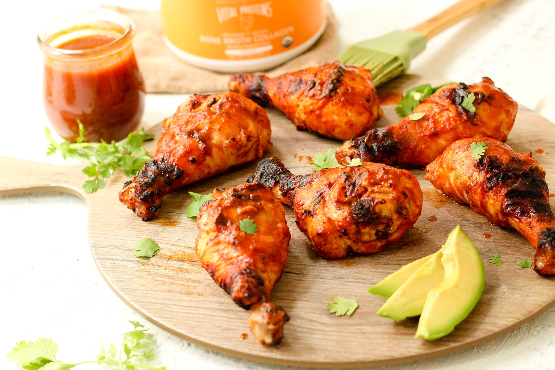 These fiesta Whole30 chicken drumsticks are marinaded in the best ever homemade Paleo and Whole30 taco sauce. The homemade taco sauce is only a few simple ingredients, and when you throw the chicken drumsticks on the grill, you have an easy dinner or protein for meal prep in under 30 minutes! Even if you want to use the oven baked method, these are the best tasting marinaded drumsticks! #whole30chickendrumsticks #homemadetacosauce #paleochickenrecipes #whole30tacosauce