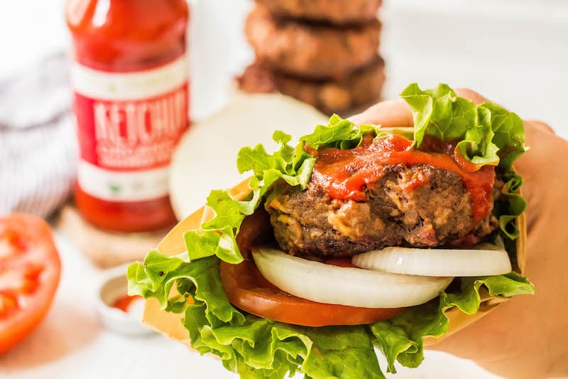 These stuffed Whole30 bacon burgers are going to be the star of your next outdoor get-together. They're easy to make on the grill or on the stovetop, and perfectly customizable for all of your party guests! These juicy burgers are full of flavor, topped with the best condiments, and great for dinner no matter if you're eating keto, Paleo or Whole30! #whole30burgers #ketoburgers #paleoburgers #whole30beefrecipes #ketobeefrecipes