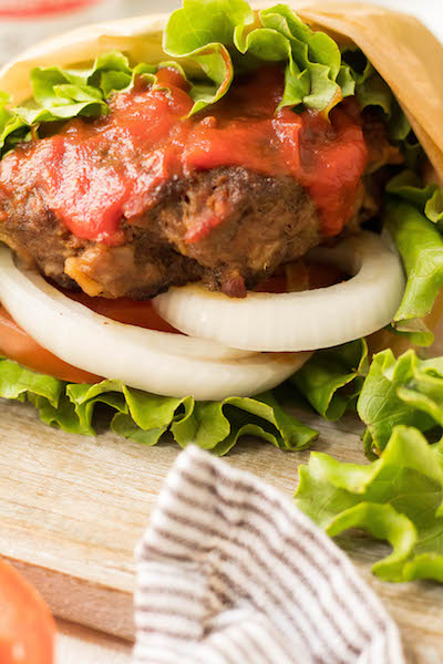 These stuffed Whole30 bacon burgers are going to be the star of your next outdoor get-together. They're easy to make on the grill or on the stovetop, and perfectly customizable for all of your party guests! These juicy burgers are full of flavor, topped with the best condiments, and great for dinner no matter if you're eating keto, Paleo or Whole30! #whole30burgers #ketoburgers #paleoburgers #whole30beefrecipes #ketobeefrecipes