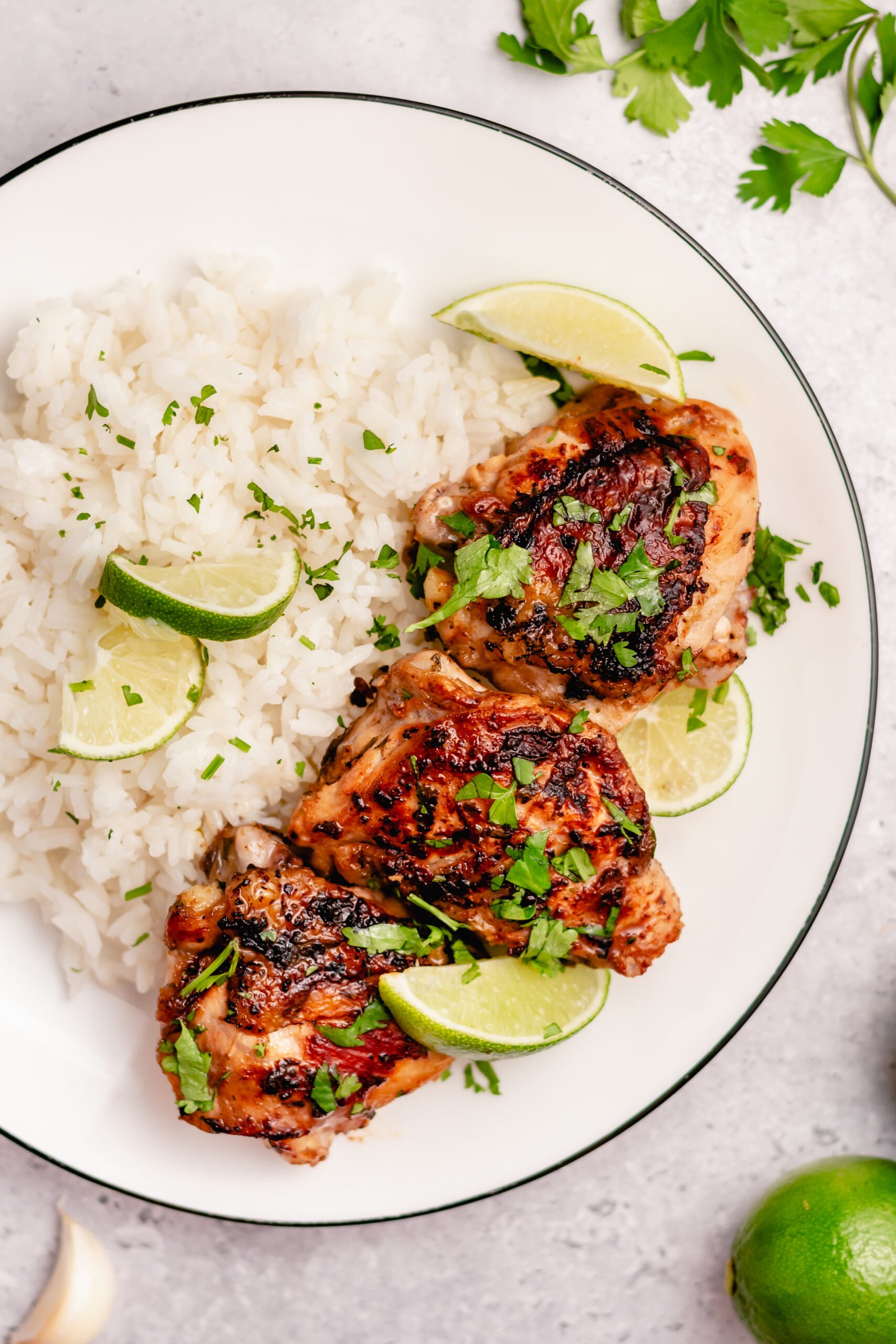 These crispy Whole30 cilantro lime chicken thighs are so delicious, and so easy to make. The skin gets perfectly crispy using this simple cooking method. They're awesome for meal prepping, or for an easy weeknight dinner. Not only are these Whole30 chicken thighs, but they're Paleo, gluten free and low carb too! #chickenthighs #cilantrolime #whole30chicken #lowcarbchicken