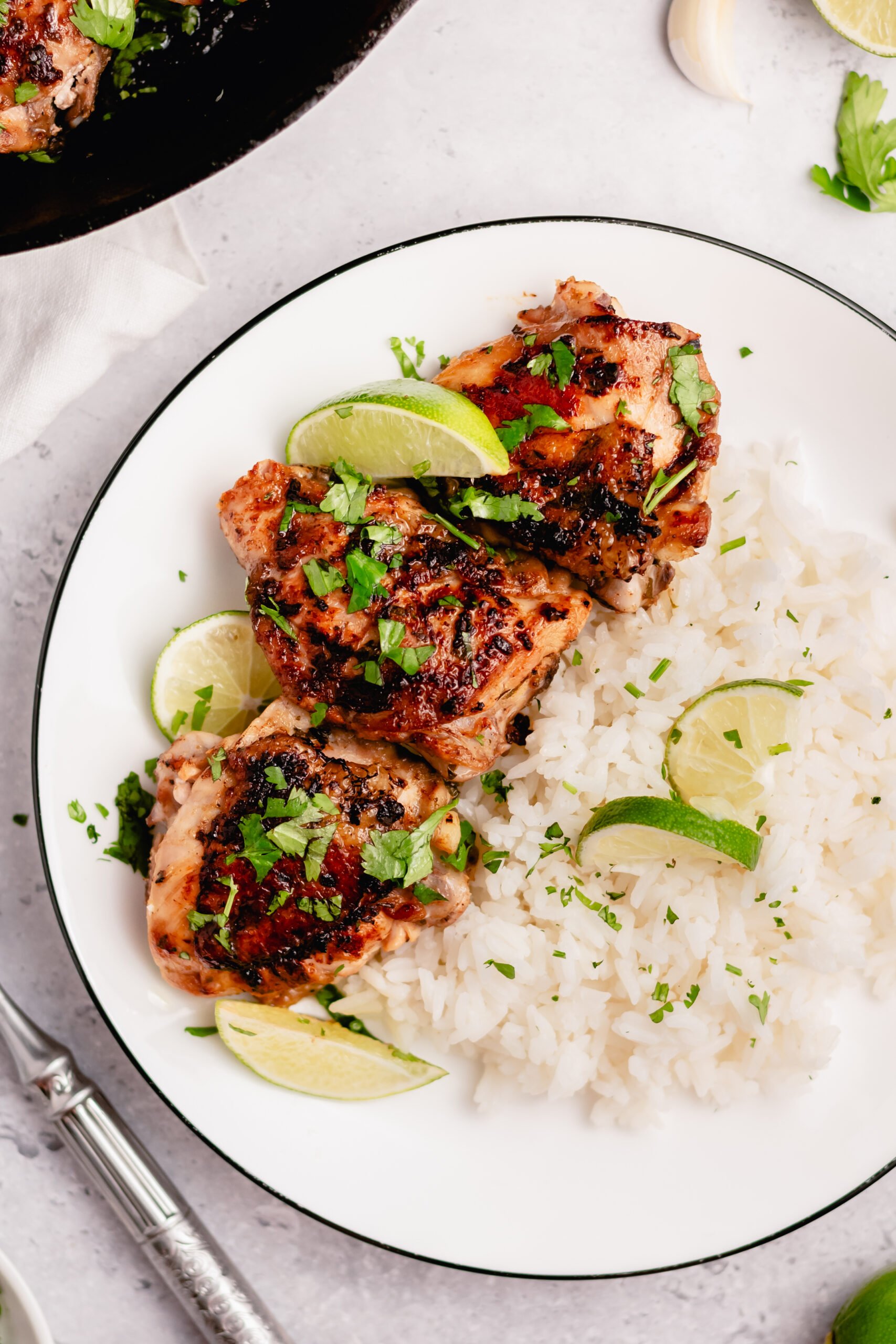 These crispy Whole30 cilantro lime chicken thighs are so delicious, and so easy to make. The skin gets perfectly crispy using this simple cooking method. They're awesome for meal prepping, or for an easy weeknight dinner. Not only are these Whole30 chicken thighs, but they're Paleo, gluten free and low carb too! #chickenthighs #cilantrolime #whole30chicken #lowcarbchicken