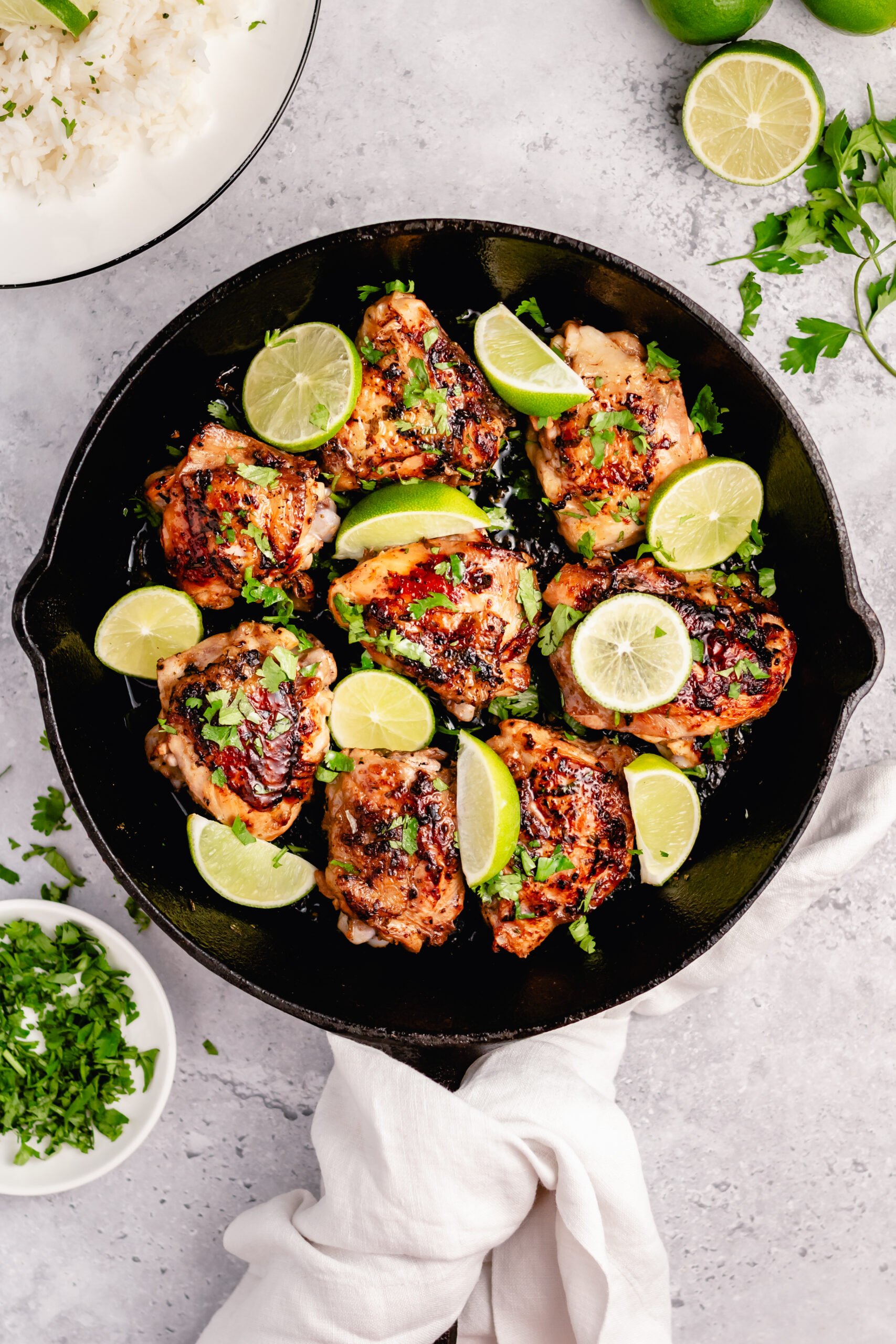 These crispy Whole30 cilantro lime chicken thighs are so delicious, and so easy to make. The skin gets perfectly crispy using this simple cooking method. They're awesome for meal prepping, or for an easy weeknight dinner. Not only are these Whole30 chicken thighs, but they're Paleo, gluten free and low carb too! #chickenthighs #cilantrolime #whole30chicken #lowcarbchicken