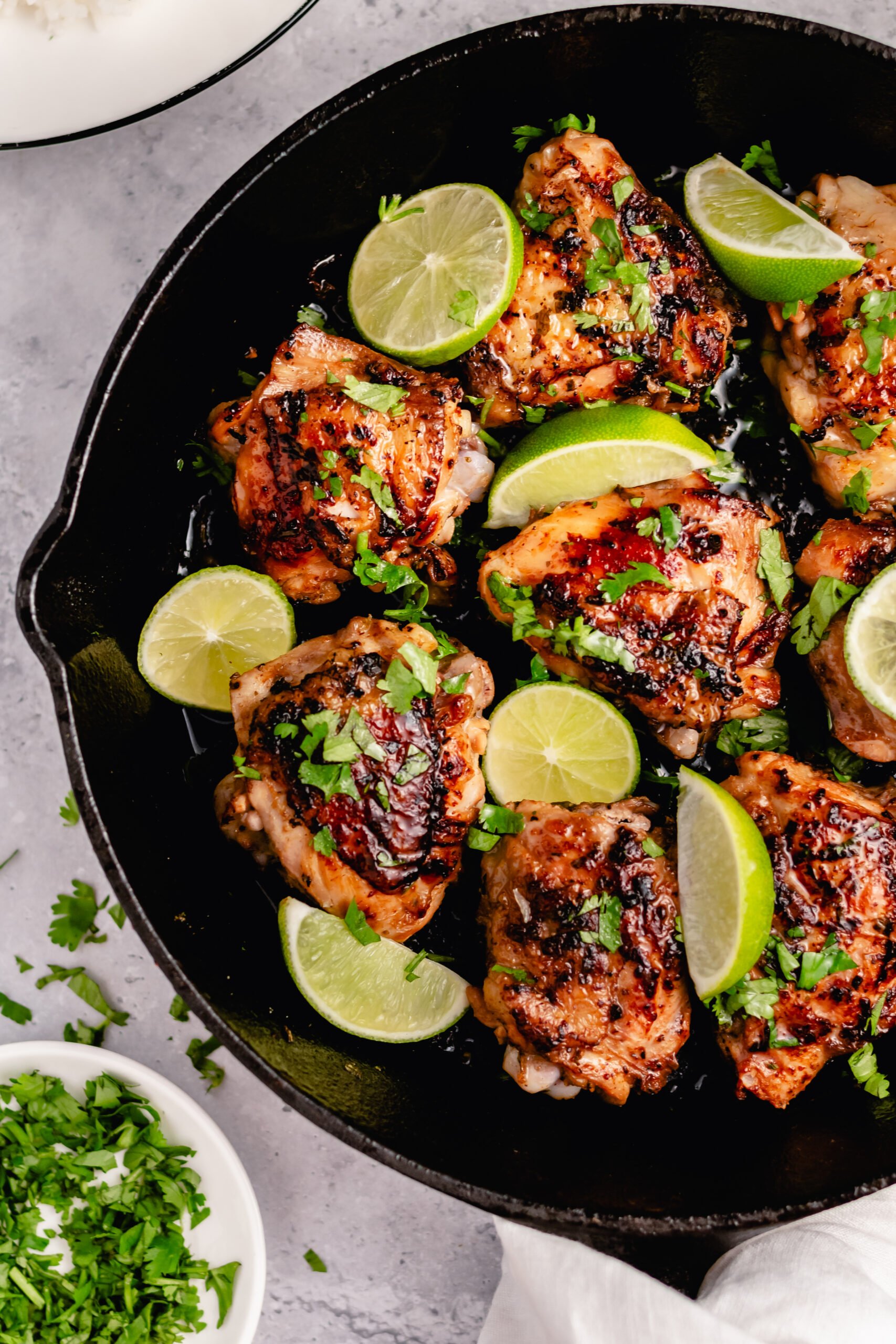 These crispy Whole30 cilantro lime chicken thighs are so delicious, and so easy to make. The skin gets perfectly crispy using this simple cooking method. They're awesome for meal prepping, or for an easy weeknight dinner. Not only are these Whole30 chicken thighs, but they're Paleo, gluten free and low carb too! #chickenthighs #cilantrolime #whole30chicken #lowcarbchicken