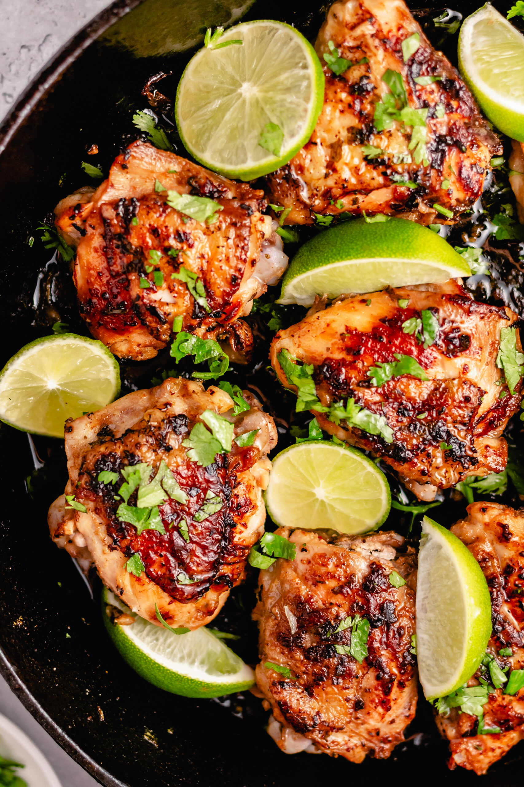 These crispy Whole30 cilantro lime chicken thighs are so delicious, and so easy to make. The skin gets perfectly crispy using this simple cooking method. They're awesome for meal prepping, or for an easy weeknight dinner. Not only are these Whole30 chicken thighs, but they're Paleo, gluten free and low carb too! #chickenthighs #cilantrolime #whole30chicken #lowcarbchicken