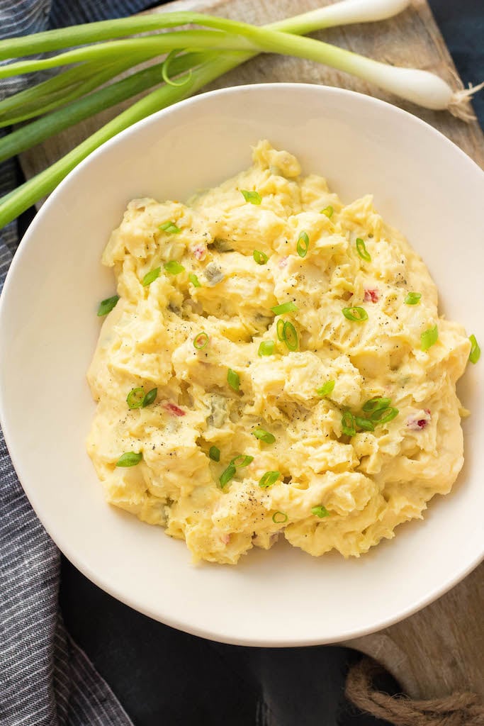 This Whole30 mustard potato salad is a family favorite. My Nana gets all the credit for it, but I tweaked it to make it totally Paleo, Whole30 and dairy-free! The pickles and yellow mustard flavors are one I always look forward to. I love making this potato salad in the summer for parties or meal prep #whole30potatosalad #paleopotatosalad #mustardpotatosalad