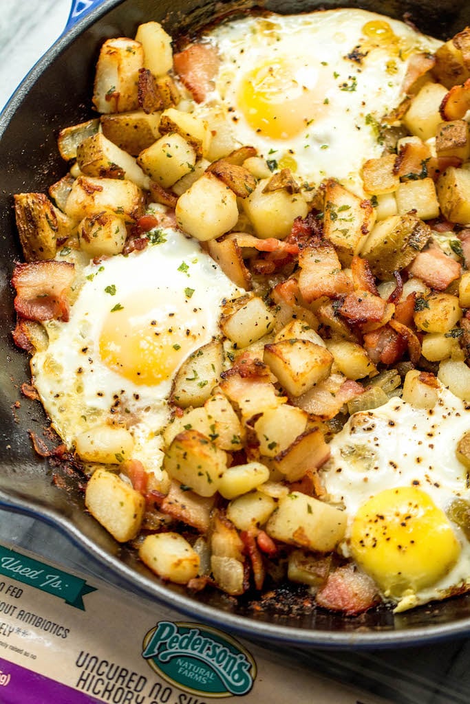 This is one of the easiest and tastiest Whole30 breakfast skillets. These country potatoes, bacon and eggs make a pretty complete and healthy breakfast in only one pan, making clean up a breeze! This paleo breakfast is a classic, and it's always a hearty, filling go-to everyone will love! #whole30breakfast #whole30breakfastskillet #whole30breakfastrecipes #whole30bacon