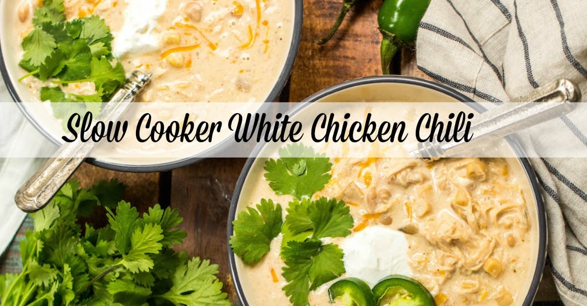 This slow cooker white chicken chili is a family recipe I grew up with, and it's every bit as hearty and delicious as it is easy to make. It's made with a few simple ingredients like white corn, shredded chicken, cream cheese, northern beans and the perfect spice combination. With only a couple of minutes of prep work, this hands off dinner is a great recipe for a chilly fall or winter night. #slowcookerchili #whitechickenchili #slowcookerwhitechickenchili