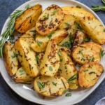 These garlicky, herb and mustard roasted potatoes are baked to crispy perfection. This Whole30 and paleo side dish takes just minutes to throw together for an easy weeknight dinner and are delicious enough to be a crowd pleaser at any holiday meal. The potato side dish requires only a handful of simple ingredients, 30 minutes in the oven and reheats great for leftovers or breakfast #whole30sidedish #whole30potatoes #paleosidedish #mustardpotatoes