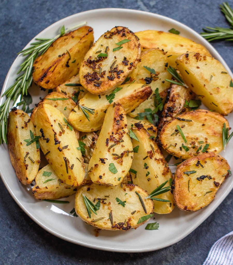 These garlicky, herb and mustard roasted potatoes are baked to crispy perfection. This Whole30 and paleo side dish takes just minutes to throw together for an easy weeknight dinner and are delicious enough to be a crowd pleaser at any holiday meal. The potato side dish requires only a handful of simple ingredients, 30 minutes in the oven and reheats great for leftovers or breakfast #whole30sidedish #whole30potatoes #paleosidedish #mustardpotatoes