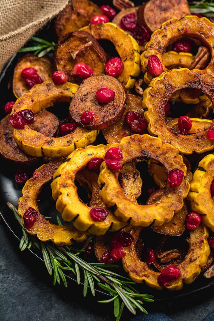 This roasted delicata squash, sweet potato and cranberry recipe is an easy, healthy side dish that has all of the best seasonal fall flavors. Made with real ingredients, it's a simple gluten-free, paleo and Whole30 Thanksgiving or holiday vegetable dish that makes a beautiful statement on the table. #whole30sidedish #delicatasquash #whole30vegetables #whole30holidayrecipes #holidayvegetables