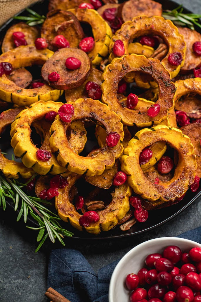 This roasted delicata squash, sweet potato and cranberry recipe is an easy, healthy side dish that has all of the best seasonal fall flavors. Made with real ingredients, it's a simple gluten-free, paleo and Whole30 Thanksgiving or holiday vegetable dish that makes a beautiful statement on the table. #whole30sidedish #delicatasquash #whole30vegetables #whole30holidayrecipes #holidayvegetables