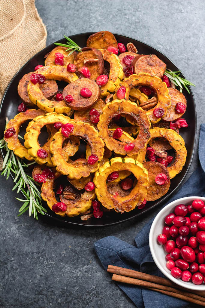This roasted delicata squash, sweet potato and cranberry recipe is an easy, healthy side dish that has all of the best seasonal fall flavors. Made with real ingredients, it's a simple gluten-free, paleo and Whole30 Thanksgiving or holiday vegetable dish that makes a beautiful statement on the table. #whole30sidedish #delicatasquash #whole30vegetables #whole30holidayrecipes #holidayvegetables