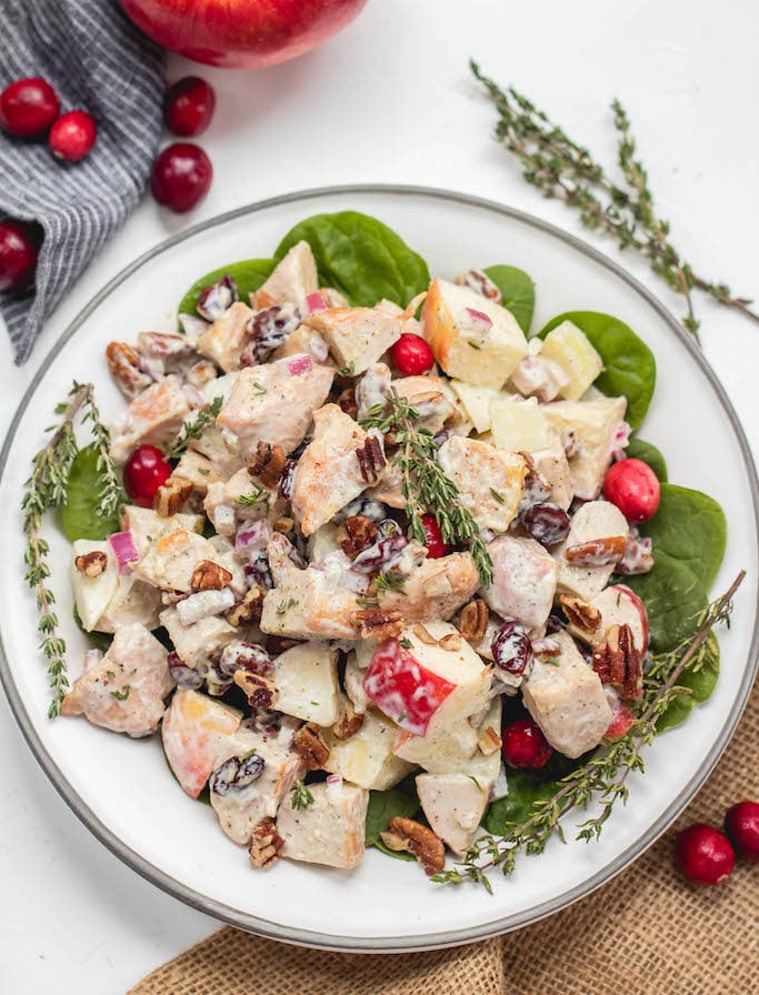 This harvest chicken salad is loaded with the best seasonal flavors like apples, pears, cranberries, pecans and thyme. It's a Whole30, Paleo, gluten and dairy-free version of a traditional mayo chicken salad that's been revamped to hold a spot on the holiday table or to be a new favorite meal prep recipe all fall and winter long. #whole30chicken #whole30chickensalad #paleochickensalad #wintersalad #harvestchickensalad