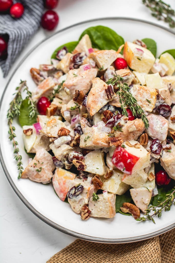 This harvest chicken salad is loaded with the best seasonal flavors like apples, pears, cranberries, pecans and thyme. It's a Whole30, Paleo, gluten and dairy-free version of a traditional mayo chicken salad that's been revamped to hold a spot on the holiday table or to be a new favorite meal prep recipe all fall and winter long. #whole30chicken #whole30chickensalad #paleochickensalad #wintersalad #harvestchickensalad