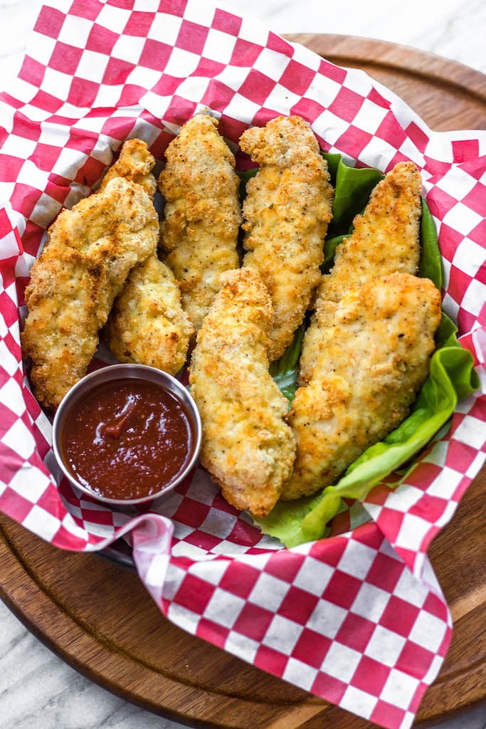 These Whole30 and Paleo air fryer chicken tenders are perfectly crispy on the outside and juicy in the middle. They're a healthy, gluten-free version of the classic chicken strips you can get at any restaurant. They're flavorful, only take a few simple ingredients and 12 minutes to cook! They're something the whole family will love and you'll feel great after eating! #whole30airfryer #whole30chicken #paleoairfryer #paleochicken #whole30recipes