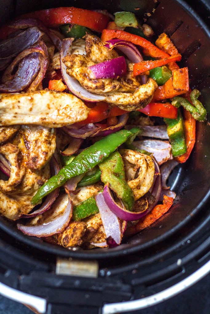 Whole30 air fryer chicken fajitas are perfect for a quick but healthy weeknight meal. These paleo fajitas can be on the table in under 30 minutes and are also gluten-free, keto, and definitely whole family approved. Eat right away or meal prep for the next day but either way they’ll be delicious. #whole30airfryer #paleoairfryer #ketoairfryer #chickenairfryer #glutenfreeairfryer #airfryerchicken