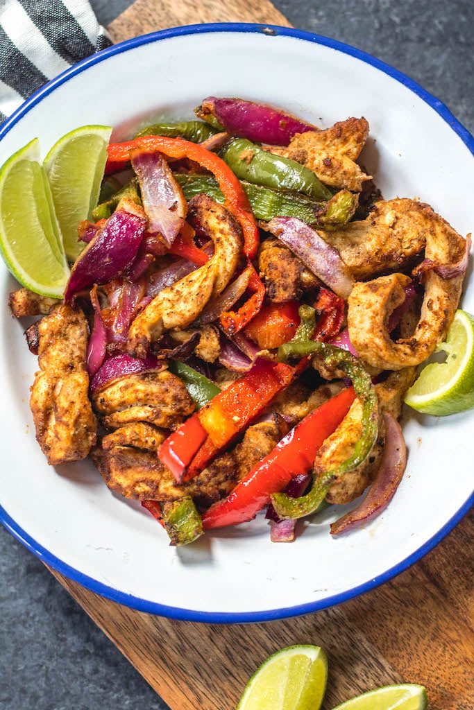 Whole30 air fryer chicken fajitas are perfect for a quick but healthy weeknight meal. These paleo fajitas can be on the table in under 30 minutes and are also gluten-free, keto, and definitely whole family approved. Eat right away or meal prep for the next day but either way they’ll be delicious. #whole30airfryer #paleoairfryer #ketoairfryer #chickenairfryer #glutenfreeairfryer #airfryerchicken
