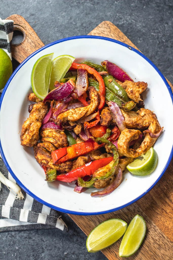 Whole30 air fryer chicken fajitas are perfect for a quick but healthy weeknight meal. These paleo fajitas can be on the table in under 30 minutes and are also gluten-free, keto, and definitely whole family approved. Eat right away or meal prep for the next day but either way they’ll be delicious. #whole30airfryer #paleoairfryer #ketoairfryer #chickenairfryer #glutenfreeairfryer #airfryerchicken