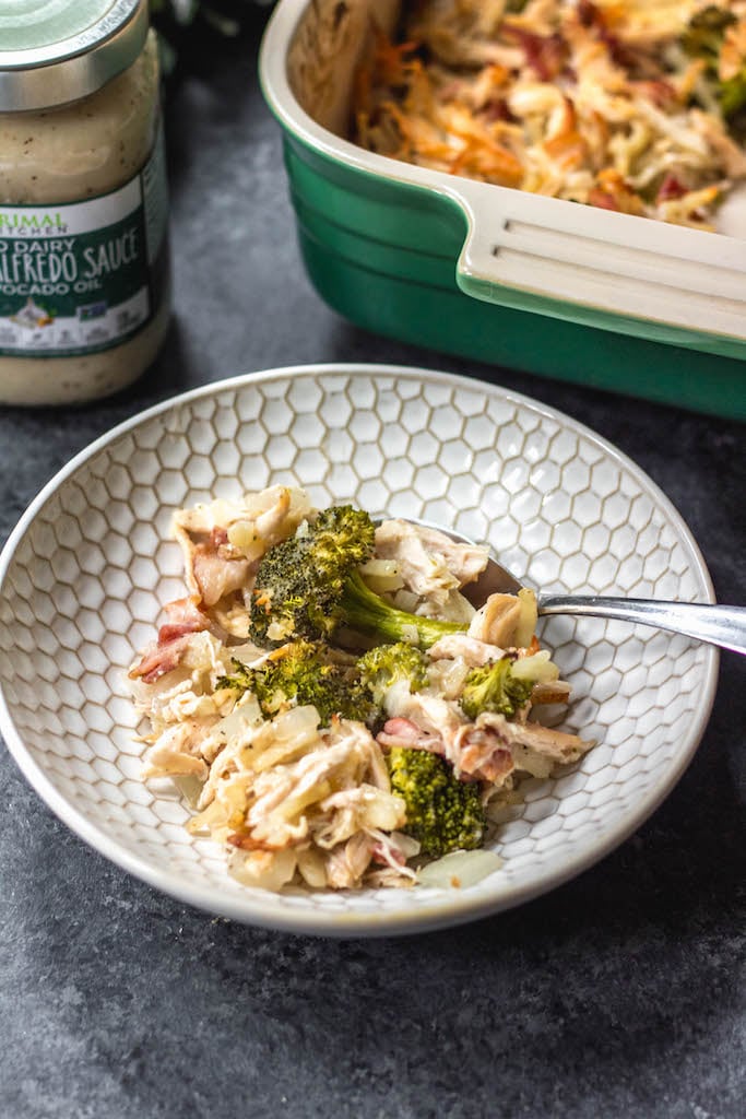 This creamy chicken and bacon alfredo casserole is loaded with veggies from the hash browns and broccoli, and it's paleo, Whole30 compliant, dairy free and gluten free. With only 7 ingredients, it really couldn't be easier to make for a quick weeknight meal or for a simple meal prep recipe. #whole30casserole #whole30chickenrecipes #whole30chickencasserole #paleocasserole #paleochickenrecipes #dairyfreecasserole