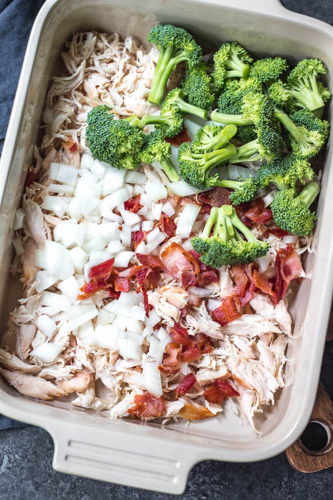 This creamy chicken and bacon alfredo casserole is loaded with veggies from the hash browns and broccoli, and it's paleo, Whole30 compliant, dairy free and gluten free. With only 7 ingredients, it really couldn't be easier to make for a quick weeknight meal or for a simple meal prep recipe. #whole30casserole #whole30chickenrecipes #whole30chickencasserole #paleocasserole #paleochickenrecipes #dairyfreecasserole