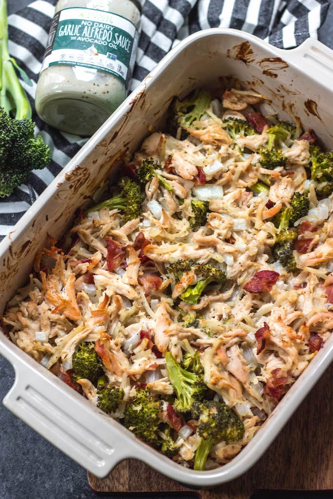 This creamy chicken and bacon alfredo casserole is loaded with veggies from the hash browns and broccoli, and it's paleo, Whole30 compliant, dairy free and gluten free. With only 7 ingredients, it really couldn't be easier to make for a quick weeknight meal or for a simple meal prep recipe. #whole30casserole #whole30chickenrecipes #whole30chickencasserole #paleocasserole #paleochickenrecipes #dairyfreecasserole