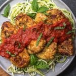 This cheeseless Whole30 chicken parm is an easy weeknight meal that's both healthy and delicious. It's paleo, dairy-free and gluten-free, and is sure to be a family favorite! If you're bored with baked chicken, this simple Whole30 chicken recipe is a great way to change up your week or your meal prep. #whole30chicken #whole30chickenparm #dairyfree #paleochicken #glutenfree #whole30chickenrecipes #glutenfreechicken