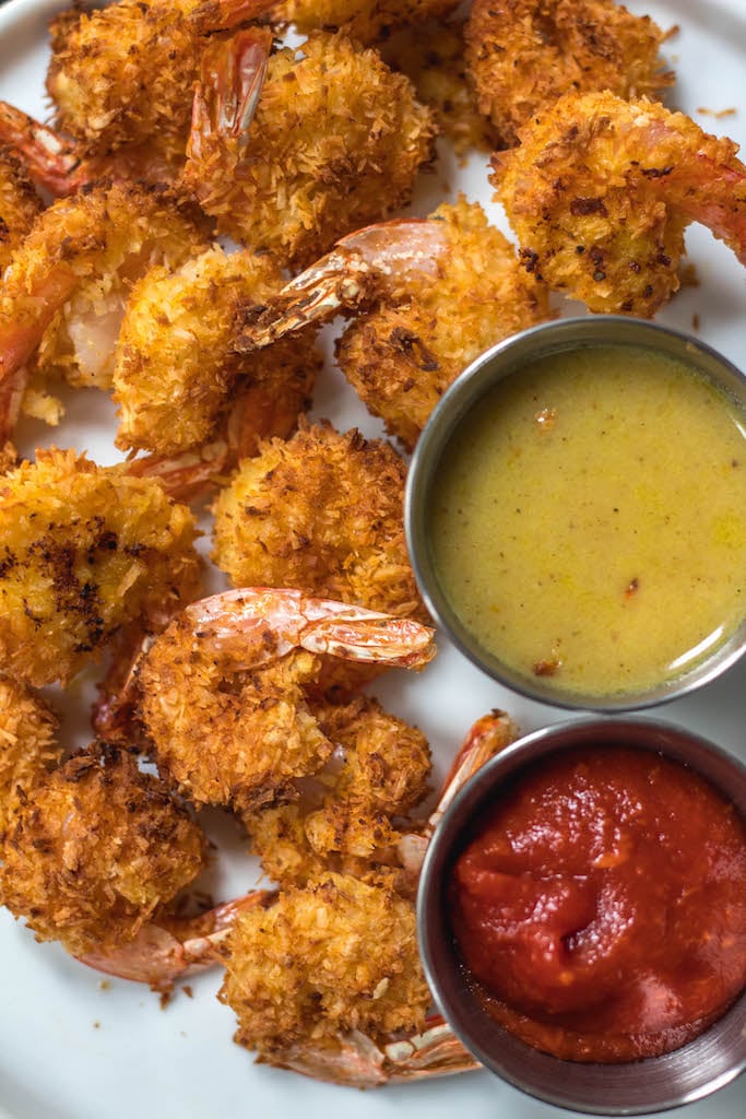 These paleo and Whole30 air fryer coconut shrimp are a healthy, gluten-free and keto alternative compared to deep frying a similar coconut shrimp recipe. With just a few simple ingredients and in less than 15 minutes you’ll have yourself a family friendly and healthy recipe everyone will love, but no one says you have to share! #whole30airfryer #whole30coconutshrimp #paleoairfryer #ketoairfryer #ketococonutshrimp #paleoairfryerrecipes