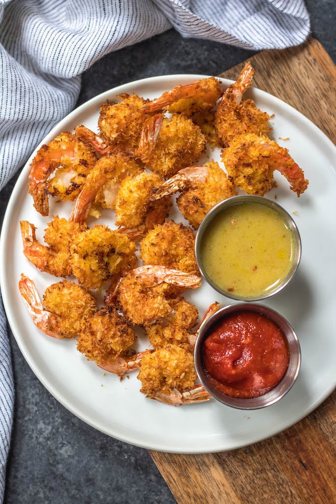 These paleo and Whole30 air fryer coconut shrimp are a healthy, gluten-free and keto alternative compared to deep frying a similar coconut shrimp recipe. With just a few simple ingredients and in less than 15 minutes you’ll have yourself a family friendly and healthy recipe everyone will love, but no one says you have to share! #whole30airfryer #whole30coconutshrimp #paleoairfryer #ketoairfryer #ketococonutshrimp #paleoairfryerrecipes