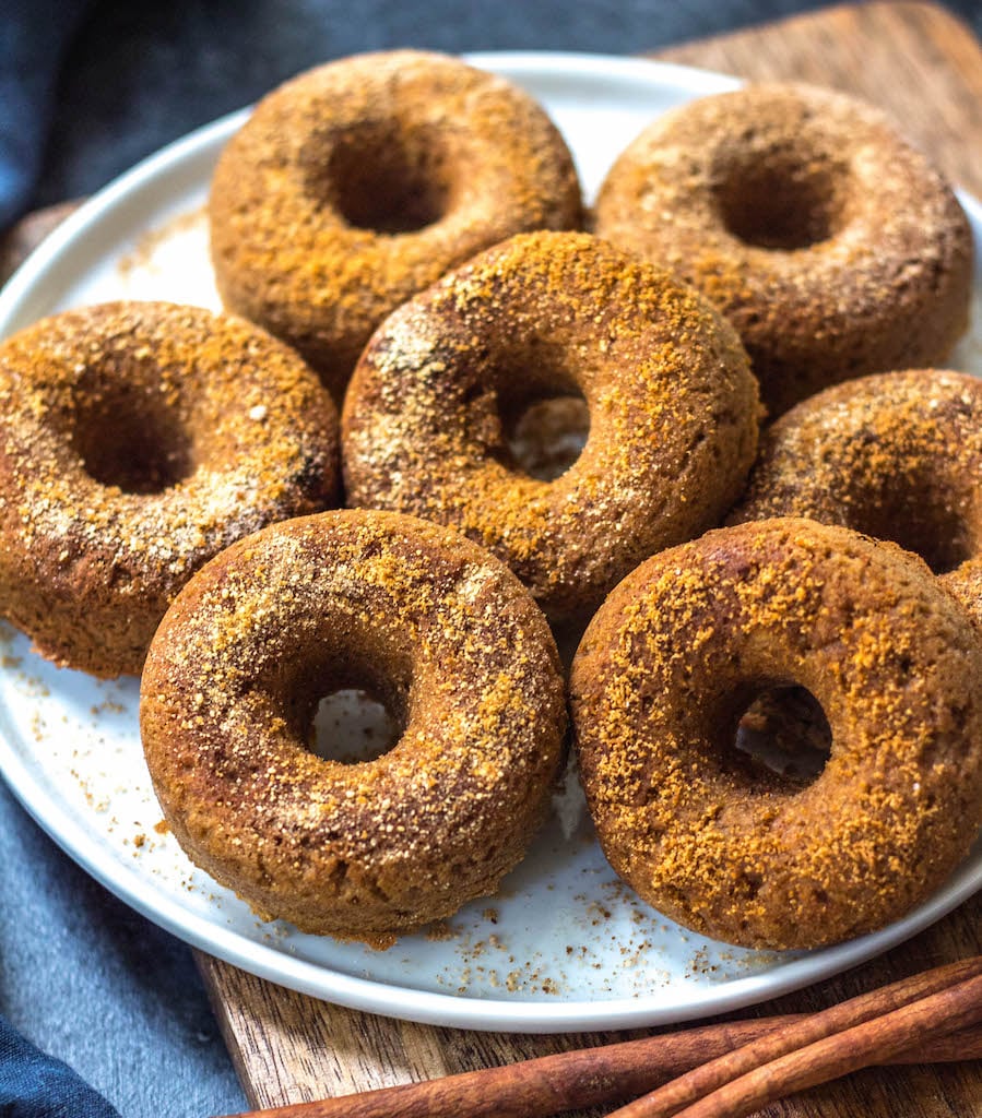 This easy homemade paleo pumpkin donut recipe makes 12 perfect, gluten free and grain free pumpkin spiced donuts. They're the best paleo fall treat that only take a few simple pantry ingredients and a few minutes in the oven. Using real pumpkin, and no refined sugar, these are a much healthier alternative to store-bought pumpkin donuts, and one that the whole family will love! #paleopumpkindonuts #paleodonuts #paleopumpkinrecipes #grainfreedonuts #glutenfreepumpkinrecipes