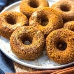 This easy homemade paleo pumpkin donut recipe makes 12 perfect, gluten free and grain free pumpkin spiced donuts. They're the best paleo fall treat that only take a few simple pantry ingredients and a few minutes in the oven. Using real pumpkin, and no refined sugar, these are a much healthier alternative to store-bought pumpkin donuts, and one that the whole family will love! #paleopumpkindonuts #paleodonuts #paleopumpkinrecipes #grainfreedonuts #glutenfreepumpkinrecipes