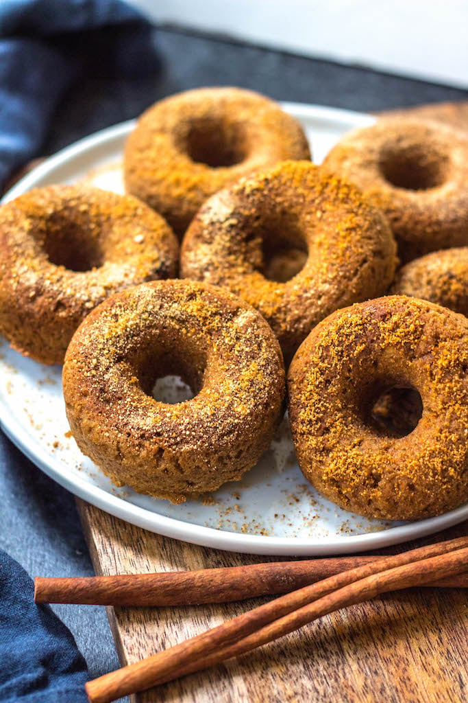 This easy homemade paleo pumpkin donut recipe makes 12 perfect, gluten free and grain free pumpkin spiced donuts. They're the best paleo fall treat that only take a few simple pantry ingredients and a few minutes in the oven. Using real pumpkin, and no refined sugar, these are a much healthier alternative to store-bought pumpkin donuts, and one that the whole family will love! #paleopumpkindonuts #paleodonuts #paleopumpkinrecipes #grainfreedonuts #glutenfreepumpkinrecipes