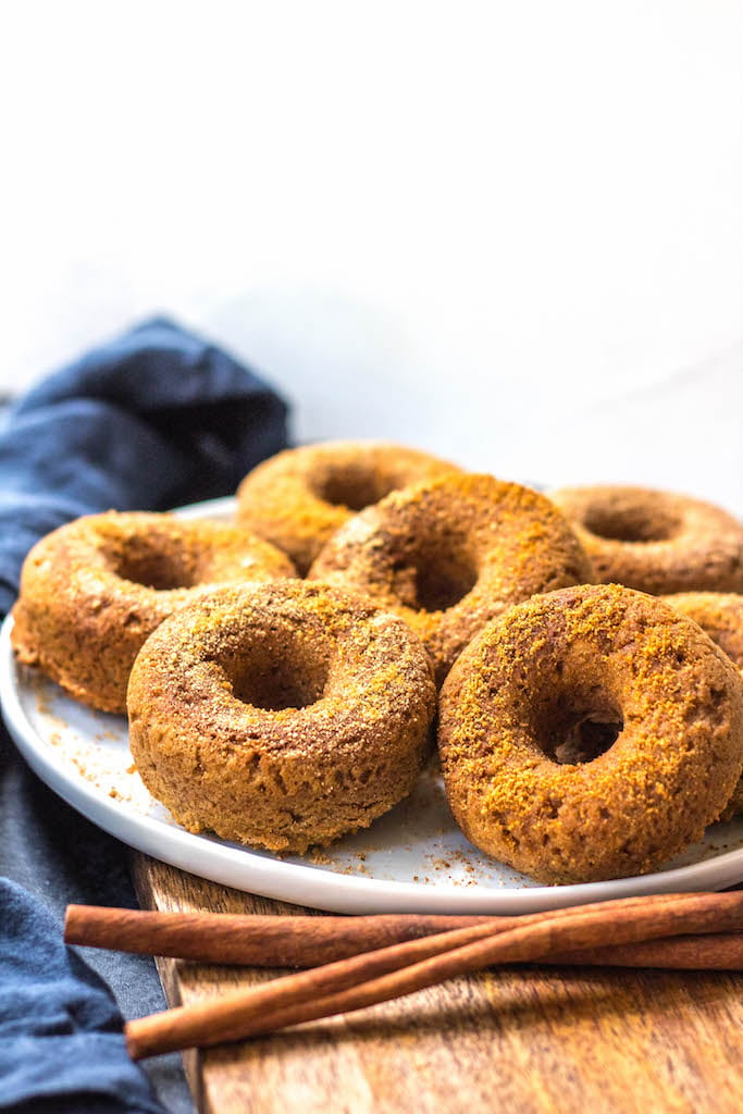 This easy homemade paleo pumpkin donut recipe makes 12 perfect, gluten free and grain free pumpkin spiced donuts. They're the best paleo fall treat that only take a few simple pantry ingredients and a few minutes in the oven. Using real pumpkin, and no refined sugar, these are a much healthier alternative to store-bought pumpkin donuts, and one that the whole family will love! #paleopumpkindonuts #paleodonuts #paleopumpkinrecipes #grainfreedonuts #glutenfreepumpkinrecipes