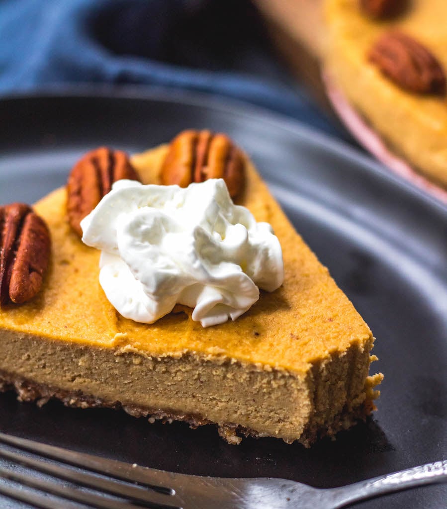 This paleo pumpkin cheesecake is the perfect dairy free and gluten free fall dessert. It's a no bake treat that everyone will love and that only takes a few minutes to prepare in a blender, or food processor. With a delicious pecan crust and creamy pumpkin filling, whether you serve this at a holiday or a cool fall weekend, it's sure to be a hit! It can also easily be made vegan! #paleodessert #paleocheesecake #dairyfreecheesecake #pumpkincheesecake #paleopumpkin