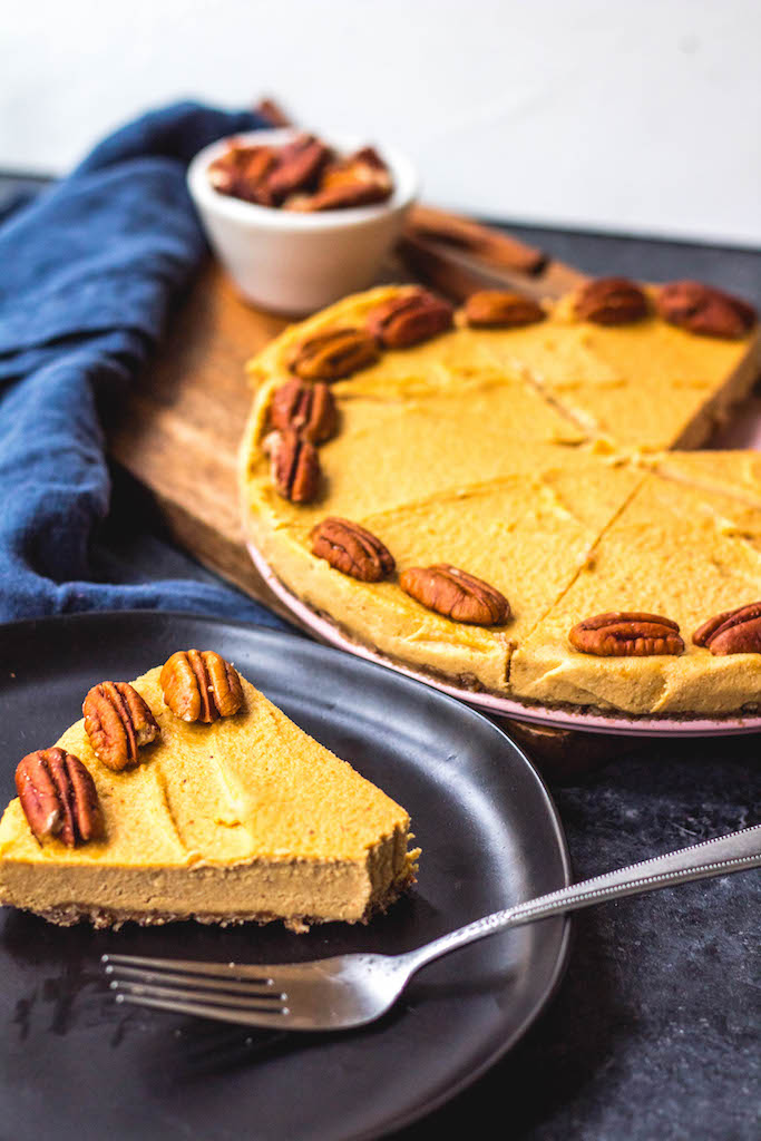 This paleo pumpkin cheesecake is the perfect dairy free and gluten free fall dessert. It's a no bake treat that everyone will love and that only takes a few minutes to prepare in a blender, or food processor. With a delicious pecan crust and creamy pumpkin filling, whether you serve this at a holiday or a cool fall weekend, it's sure to be a hit! It can also easily be made vegan! #paleodessert #paleocheesecake #dairyfreecheesecake #pumpkincheesecake #paleopumpkin