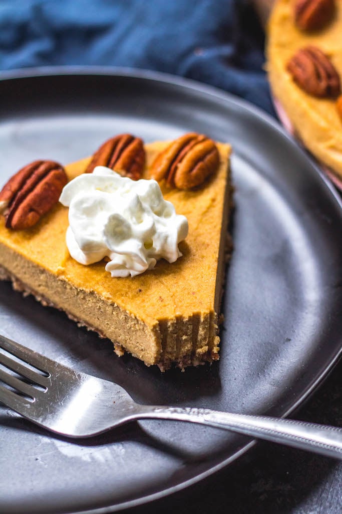 This paleo pumpkin cheesecake is the perfect dairy free and gluten free fall dessert. It's a no bake treat that everyone will love and that only takes a few minutes to prepare in a blender, or food processor. With a delicious pecan crust and creamy pumpkin filling, whether you serve this at a holiday or a cool fall weekend, it's sure to be a hit! It can also easily be made vegan! #paleodessert #paleocheesecake #dairyfreecheesecake #pumpkincheesecake #paleopumpkin