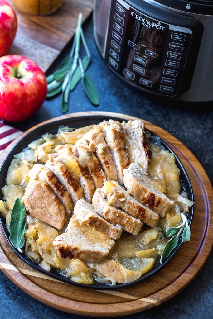 These pressure cooker apple dijon pork tenderloins are a simple fall weeknight meal or great for meal prepping. It's a Paleo, Whole30, gluten-free recipe and made in under 30 minutes. With only a few simple ingredients, this healthy pork tenderloin recipe will be a family favorite that can be on the table in no time #whole30porkrecipes #pressurecookerrecipes #paleoporkrecipes #appledijonporktenderloin #porktenderloin