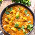 This paleo and Whole30 slow cooker chicken tikka masala recipe is every bit as easy as it is delicious. It's a truly set it and forget it recipe that only requires a few simple ingredients, chicken and a crock pot. The end result is a tasty, healthy and family friendly weeknight dinner or meal for meal prep for the week! It's gluten-free, dairy-free and keto, so it's great for any type of eater in your family! #whole30slowcooker #whole30chickentikkamasala #lowcarbslowcooker #ketoslowcooker #paleochickentikkamasala