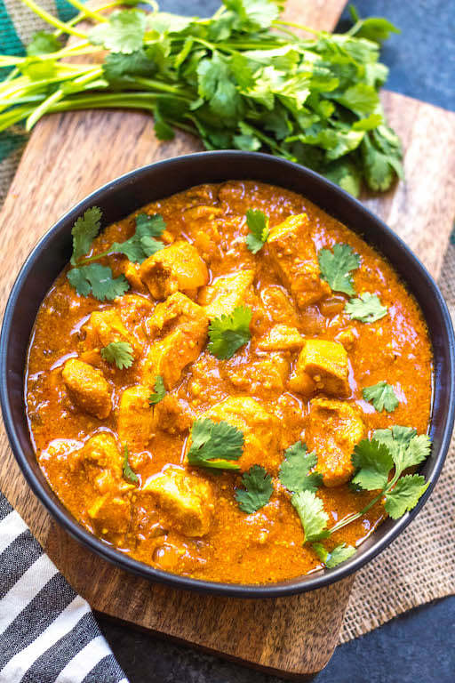 This paleo and Whole30 slow cooker chicken tikka masala recipe is every bit as easy as it is delicious. It's a truly set it and forget it recipe that only requires a few simple ingredients, chicken and a crock pot. The end result is a tasty, healthy and family friendly weeknight dinner or meal for meal prep for the week! It's gluten-free, dairy-free and keto, so it's great for any type of eater in your family! #whole30slowcooker #whole30chickentikkamasala #lowcarbslowcooker #ketoslowcooker #paleochickentikkamasala