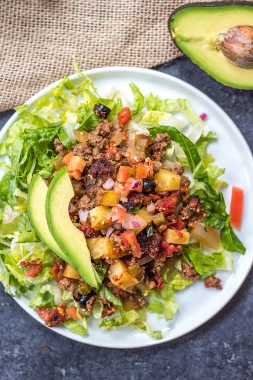 This Whole30 taco casserole is an awesome meal prep recipe or perfect for a paleo or gluten-free weeknight meal. Preparation is simple, just mix everything together, oven bake it, and pull out a delicious beef taco casserole for the family! It's a great way to use up ground beef, and it's healthy recipe option that's loaded with veggies #whole30tacocasserole #whole30casserole #whole30groundbeefrecipes #paleocasserole #paleotacocasserole #glutenfreecasserole