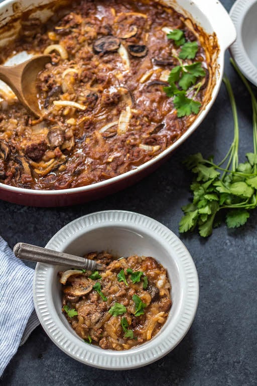 This Whole30 casserole is everything you love about classic salisbury steak, but it's made with only the good stuff! Healthy, hearty and cozy, this salisbury steak casserole is loaded with vegetables, a thick gravy, and baked all in one dish. It's a perfect Paleo and gluten-free family friendly weeknight dinner, or a great meal prep recipe for leftovers that reheat wonderfully! #whole30casserole #whole30beefrecipes #whole30beefcasserole #paleocasserole #paleobeefrecipes #salisburysteak